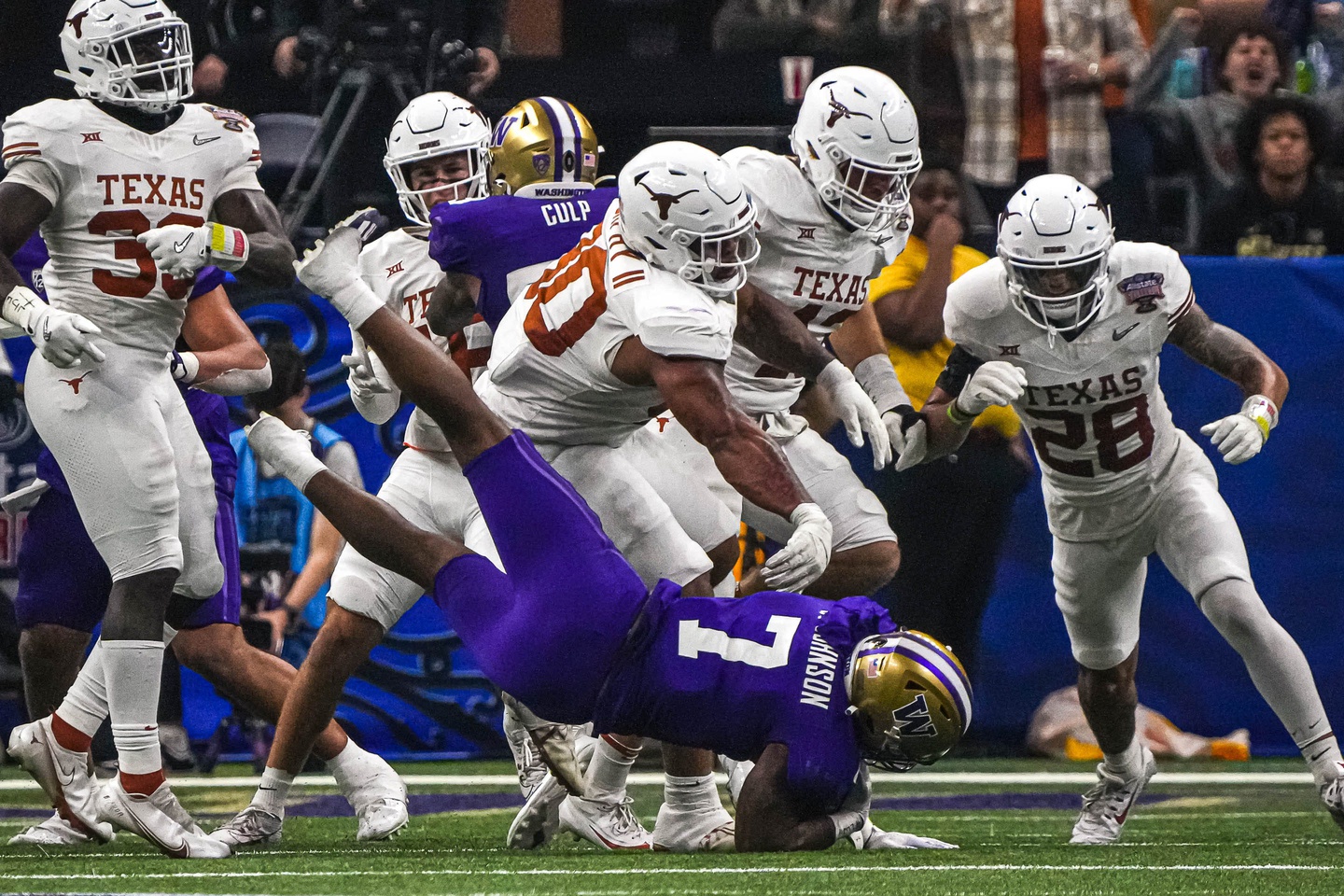 Texas Longhorns defensive lineman Byron Murphy II (90) throws Washington running back Dillon Johnson (7) to the ground during the Sugar Bowl College Football Playoff semifinals. © Aaron E. Martinez/American-Statesman / USA TODAY NETWORK
